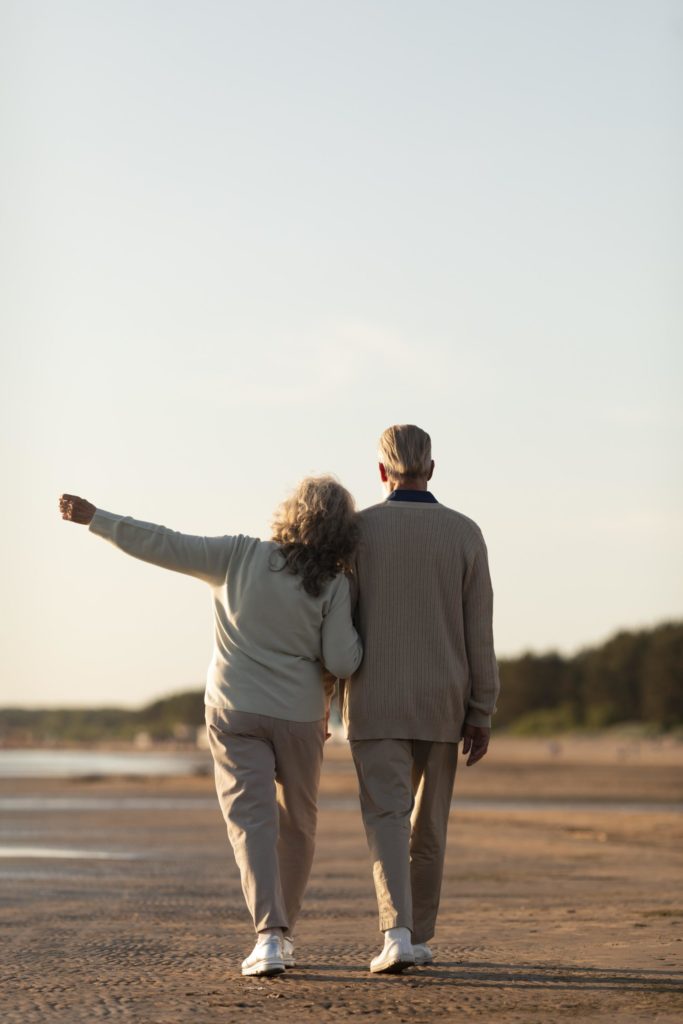 Senior couple seaside full shot